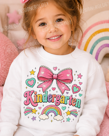 Cute Kindergarten PNG featuring a pink coquette bow, pastel rainbow, hearts, and colorful lettering for back-to-school sublimation projects, t-shirts, tote bags, mugs, and print-on-demand products.